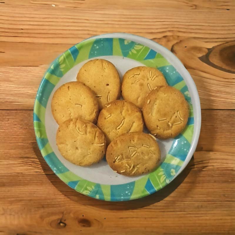 Image: A plate of golden-brown Alu Bhujia Cookies, showcasing their unique savory texture and rich, spiced flavor.