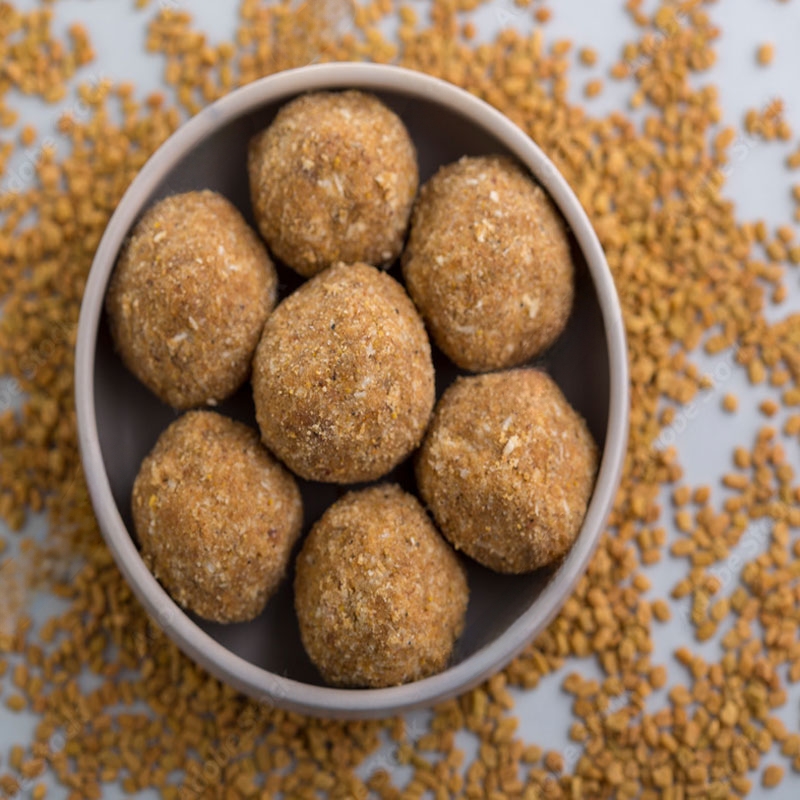 Image of Methi Laddu - A traditional Indian sweet made with fenugreek seeds, jaggery, and nuts.