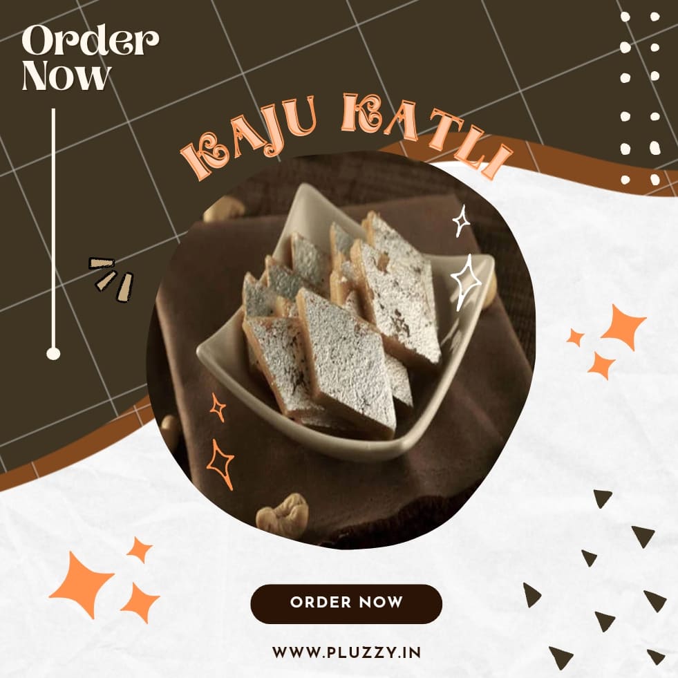 Kaju katli: A square-shaped Indian sweet, made primarily of cashews, displayed on a white plate against a contrasting background. The smooth, thin, diamond-cut slices of the sweet glisten with a light golden hue, invitingly arranged and garnished with silver leaf.