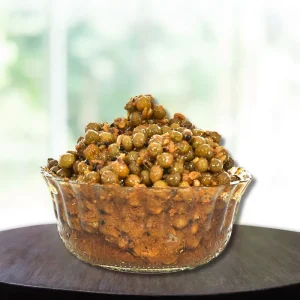 A jar of Kair pickle, a traditional Indian condiment made from raw green mangoes and spices.