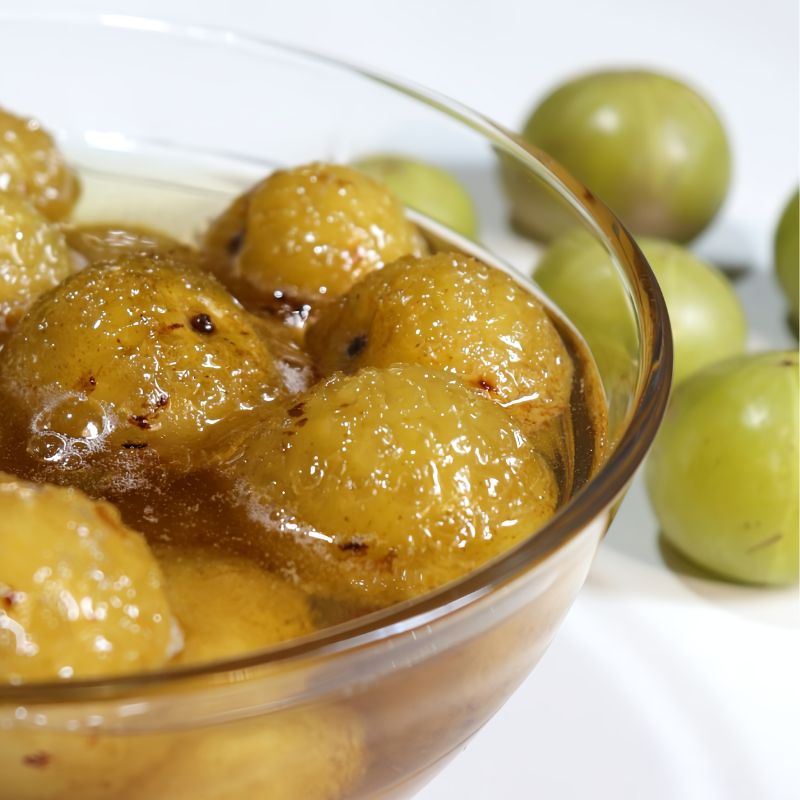 Amla Murabba image could be: 'A glass jar filled with Amla Murabba, a traditional Indian gooseberry preserve sweetened with sugar or jaggery, rich in Vitamin C and antioxidants.